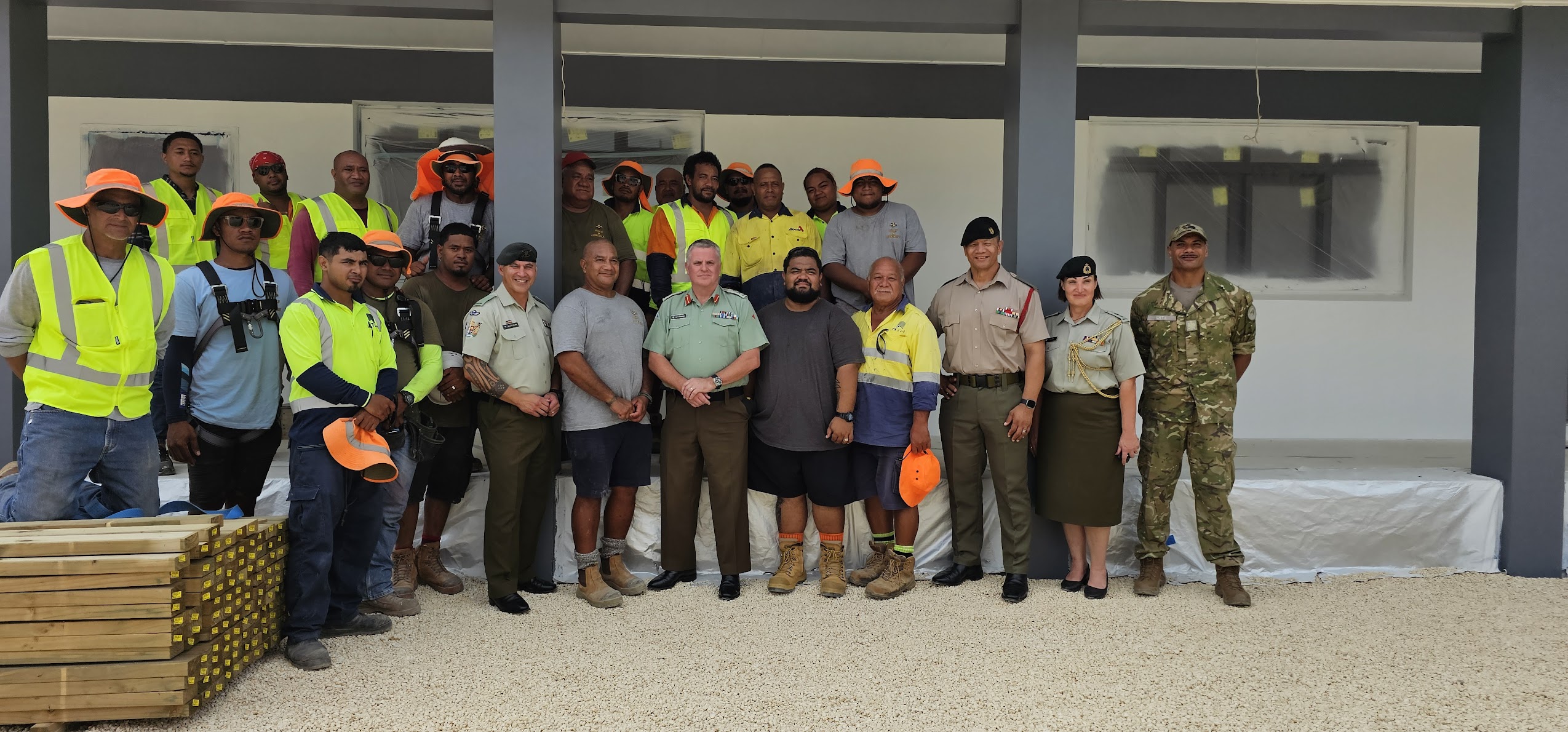 Build N Concrete Ltd team members and project partners standing together at a completed construction project site.