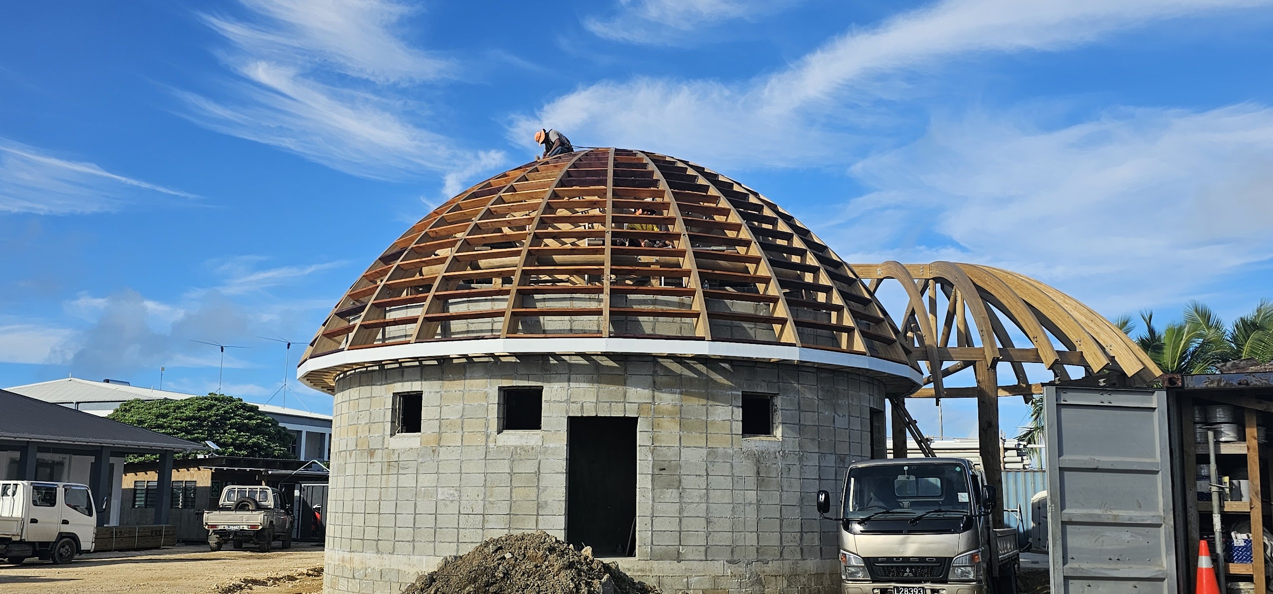Large curved timber roof structure under construction by Build N Concrete Ltd featuring specialised framing and commercial building works.
