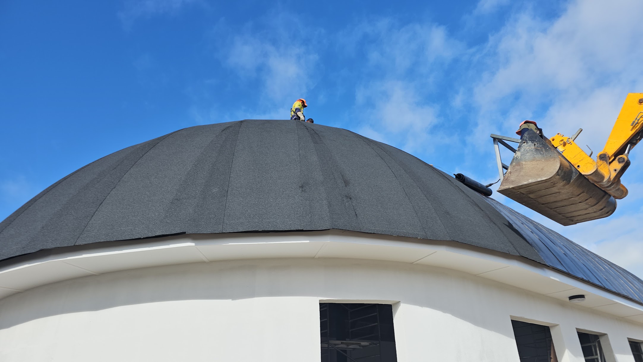 Workers installing roofing systems on a large-scale commercial construction project by Build N Concrete Ltd.