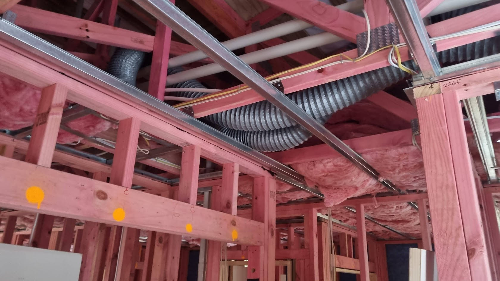 Interior structural framing and building services installation during an active construction project.